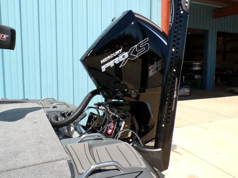 Slide: The Image of Phoenix 920 Elite 2025 boat with Mercury Pro XS engine, docked near blue building. - 7