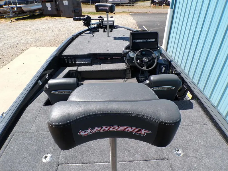 Slide: The Image of 2025 Phoenix 920 Elite boat interior with steering wheel and electronics, featuring branded seating. - 8