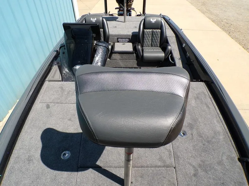Slide: The Image of 2025 Phoenix 920 Elite boat interior with gray seating and carpeted deck. - 9