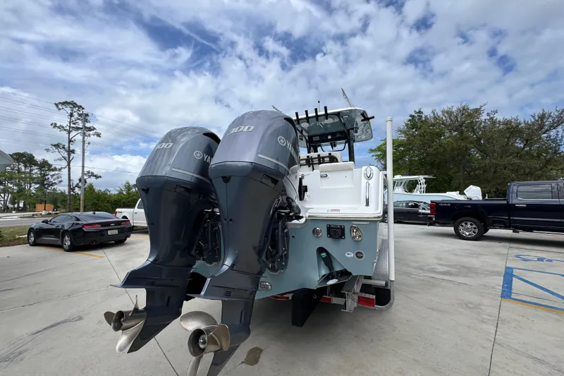 Slide: The Image of 2020 Sea Hunt Gamefish 30 with dual Yamaha engines in a parking lot. - 12