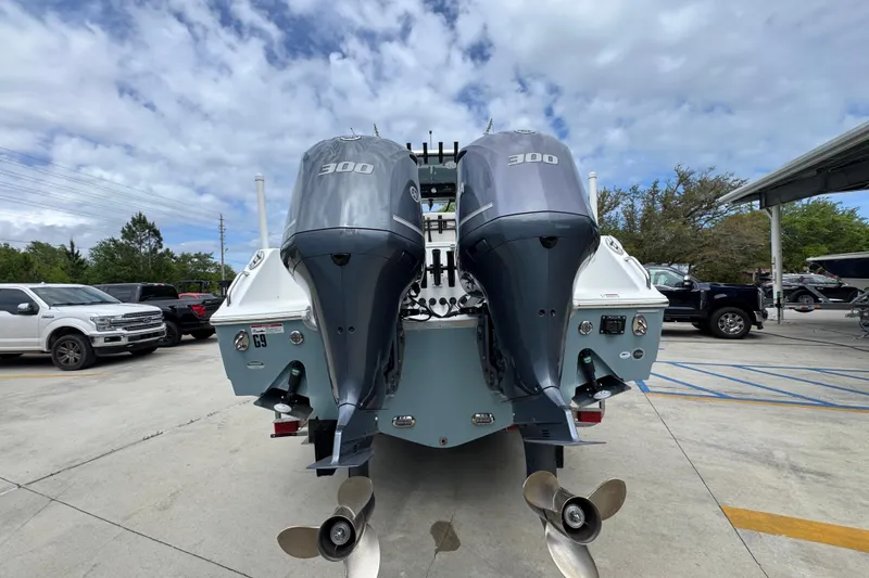 Slide: The Image of 2020 Sea Hunt Gamefish 30 with twin 300 horsepower engines, parked outdoors. - 13