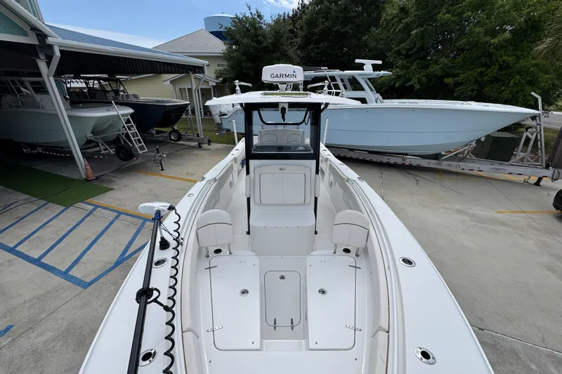 Slide: The Image of 2020 Sea Hunt Gamefish 30 Forward Seating boat in a marina, showcasing sleek design. - 21