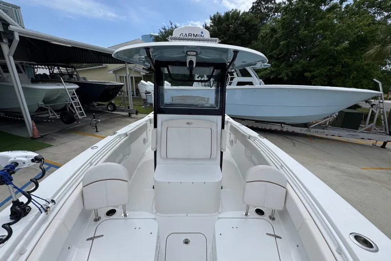 Slide: The Image of 2020 Sea Hunt Gamefish 30 boat with forward seating, docked at a marina. - 22