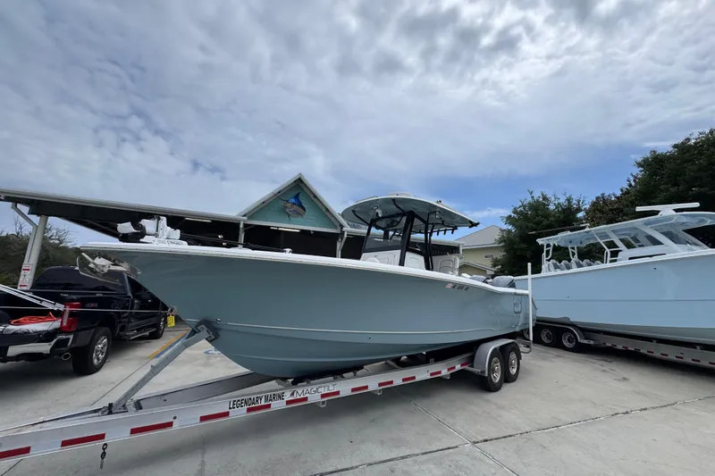 Slide: The Image of 2020 Sea Hunt Gamefish 30 boat on trailer under cloudy sky. - 3