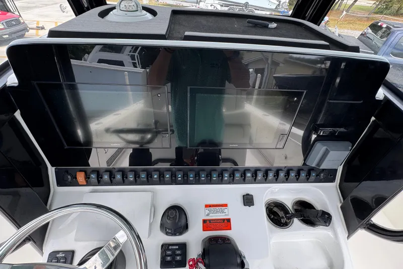 Slide: The Image of 2020 Sea Hunt Gamefish 30 helm with dual screens and control panel. - 31