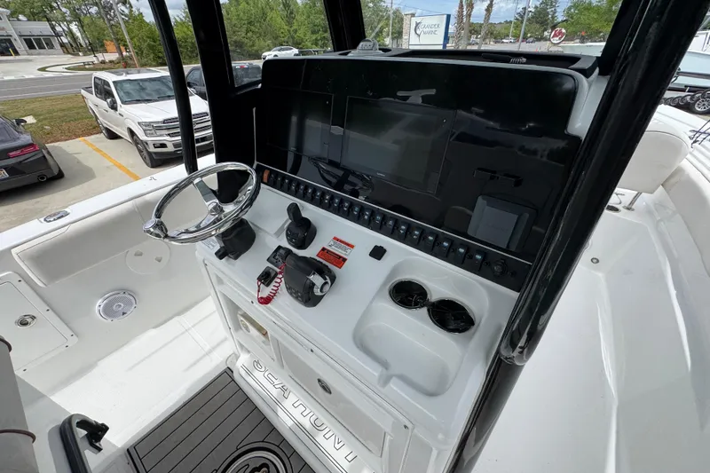 Slide: The Image of 2020 Sea Hunt Gamefish 30 boat console with steering wheel and controls. - 33