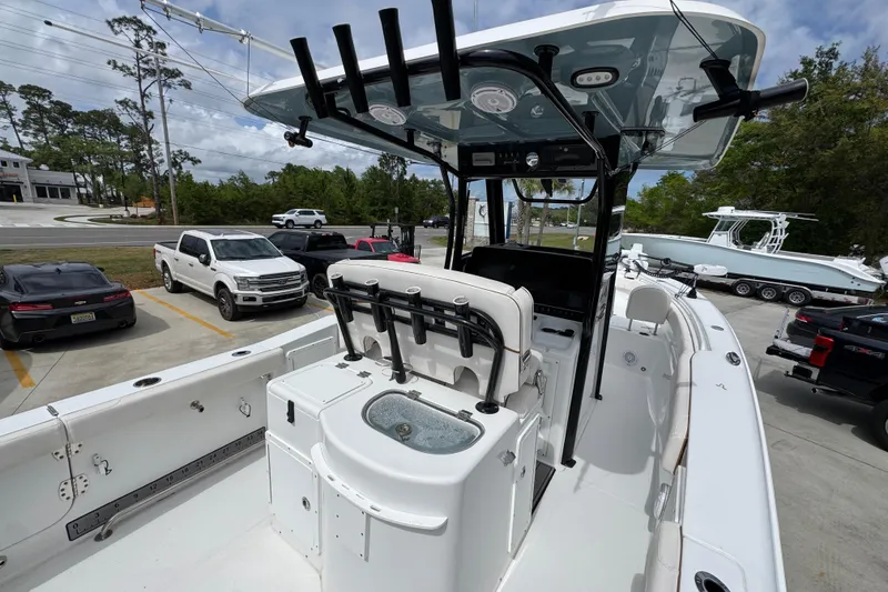 Slide: The Image of 2020 Sea Hunt Gamefish 30 boat with forward seating, parked in a lot with vehicles. - 35