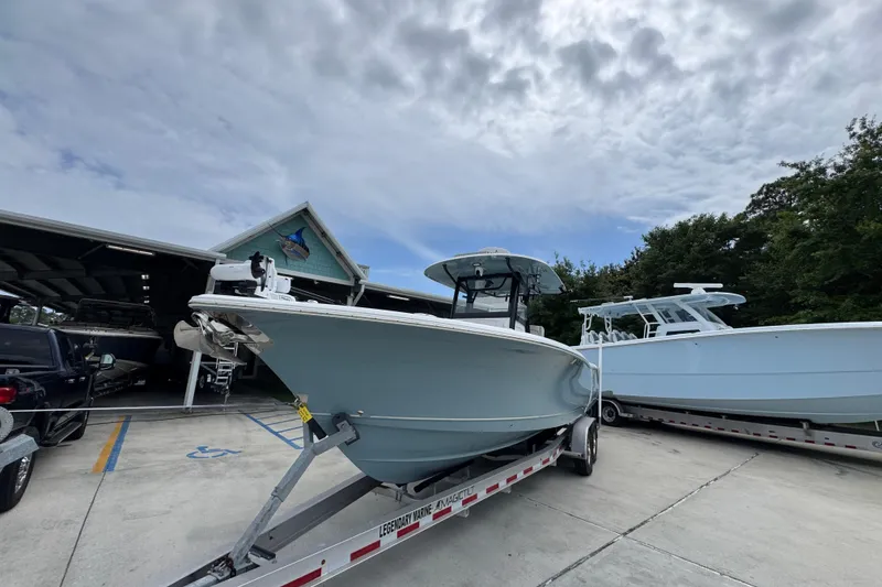 Slide: The Image of 2020 Sea Hunt Gamefish 30 boat on trailer, parked outdoors near a building. - 4
