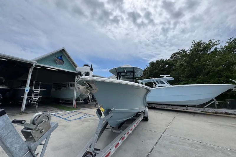 Slide: The Image of 2020 Sea Hunt Gamefish 30 Forward Seating boat on trailer at marina. - 5