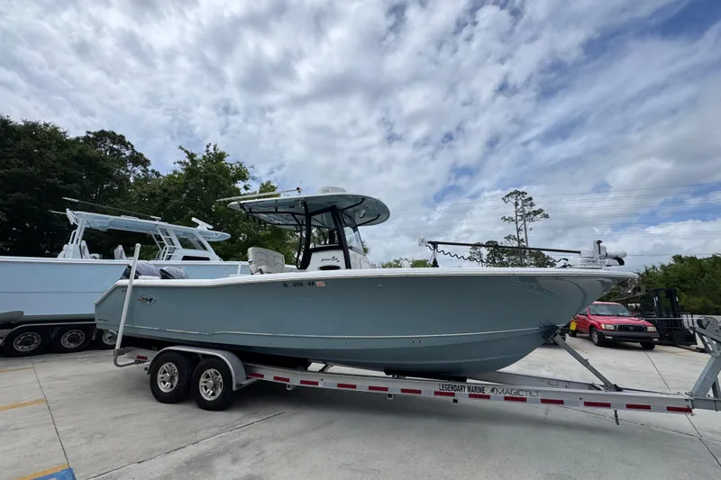 Slide: The Image of 2020 Sea Hunt Gamefish 30 boat on trailer under cloudy sky. - 8