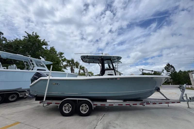 Slide: The Image of 2020 Sea Hunt Gamefish 30 boat on trailer under cloudy sky. - 9