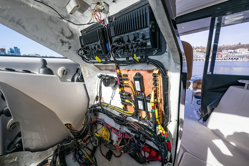 Slide: The Image of Electrical panel inside 2006 Tiara Yachts 4000 Sovran, showcasing wiring and components. Clean easy to access wiring which is easy to service if needed - 23