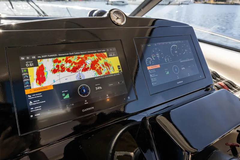 Slide: The Image of Garmin navigation screens on 2006 Tiara Yachts 4000 Sovran, displaying Radar and engine data data. - 37