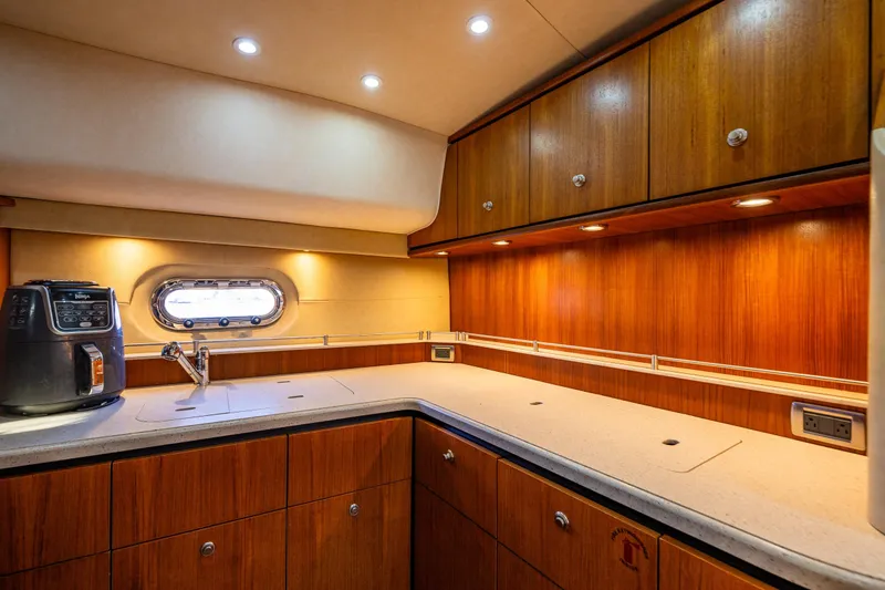 Slide: The Image of Luxurious 2006 Tiara Yachts 4000 Sovran galley with wood cabinetry and modern appliances. - 46