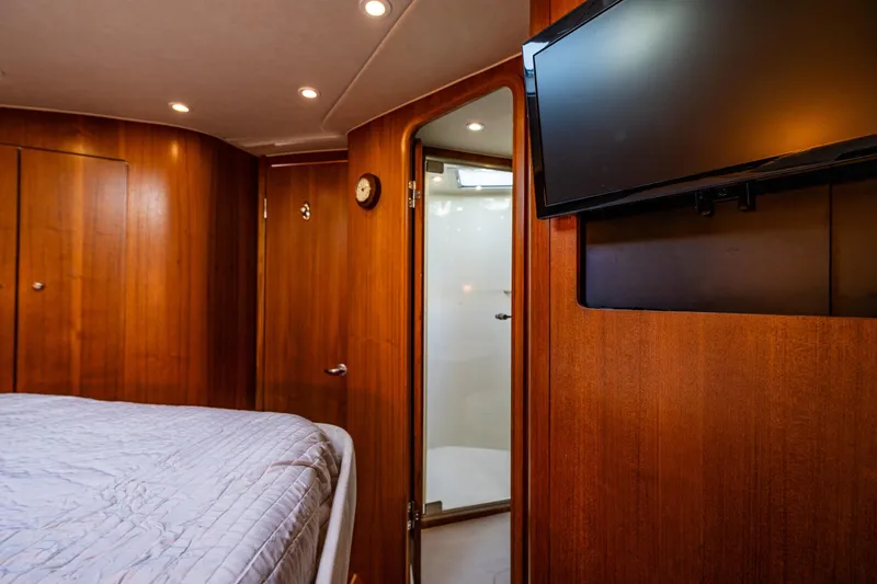 Slide: The Image of Luxurious cabin interior of 2006 Tiara Yachts 4000 Sovran with wood paneling and TV. - 51