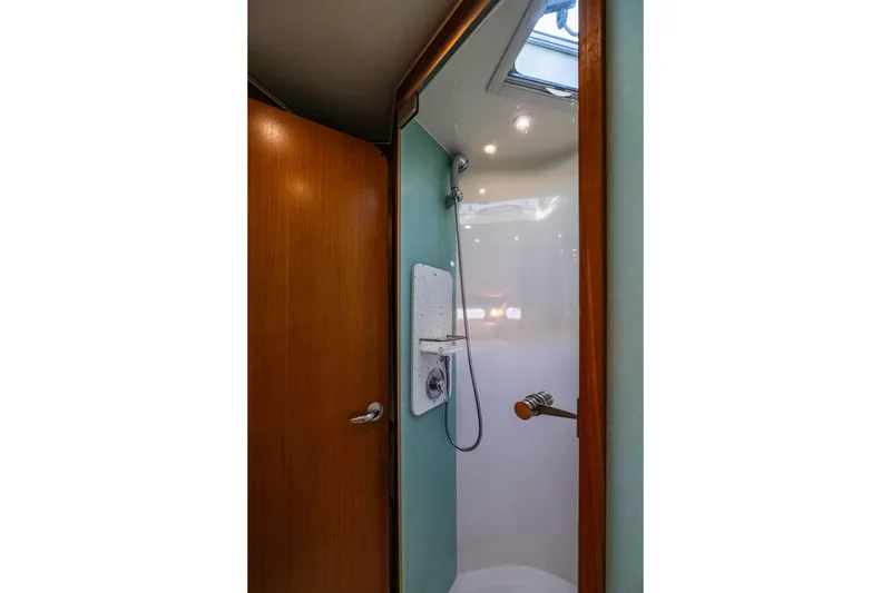 Slide: The Image of Shower area inside 2006 Tiara Yachts 4000 Sovran, featuring wooden door and modern fixtures. - 52