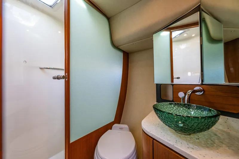 Slide: The Image of Luxurious bathroom in 2006 Tiara Yachts 4000 Sovran with glass sink and modern fixtures. - 53