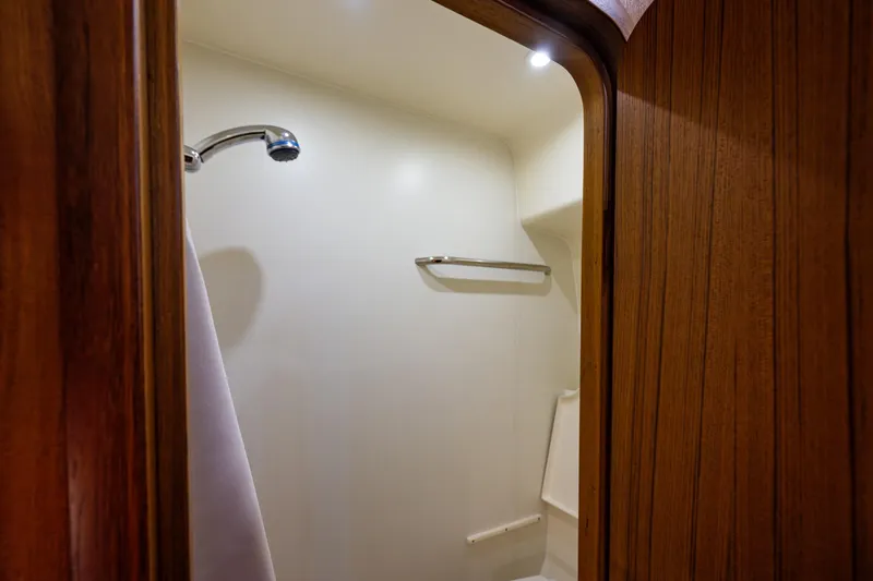 Slide: The Image of Shower area inside 2006 Tiara Yachts 4000 Sovran, featuring wooden paneling and modern fixtures. - 55