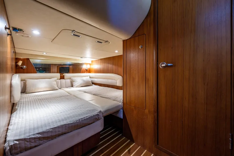 Slide: The Image of Luxurious cabin interior of 2006 Tiara Yachts 4000 Sovran with twin beds and wooden finish. Beds have a divider between shown joining the beds together - 56