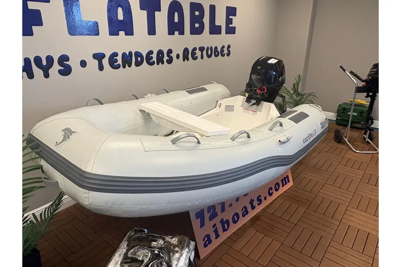 Slide: The Image of Inflatable Caribe L-8 boat, 2026 model, displayed indoors with motor and accessories. - 4