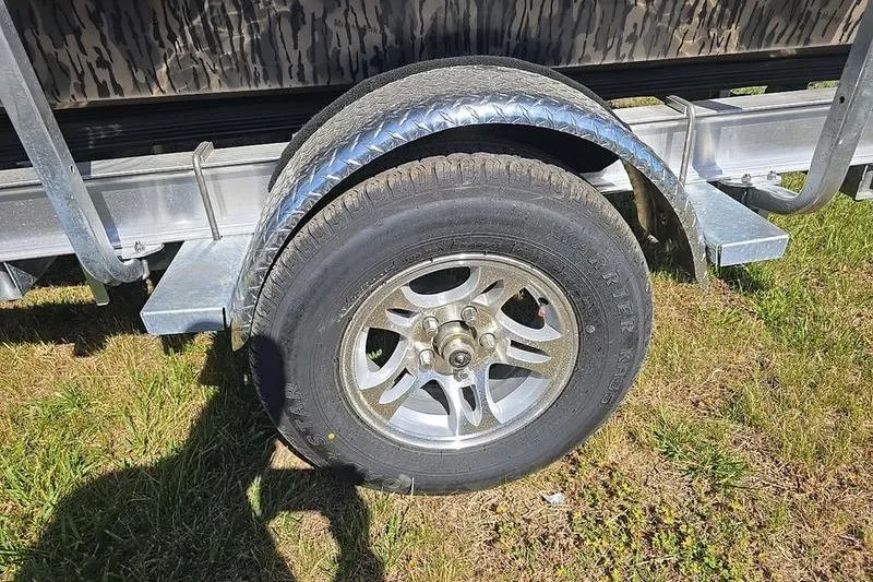 Slide: The Image of Trailer wheel of 2026 Havoc 1760 VJST on grass, featuring metal fender and alloy rim. - 3
