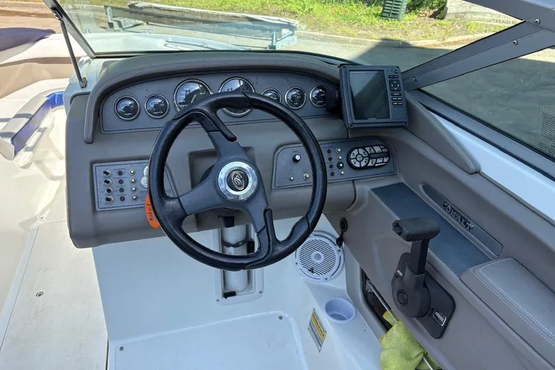 Slide: The Image of Steering console of a 2002 Cobalt 240 boat with gauges and controls. - 10