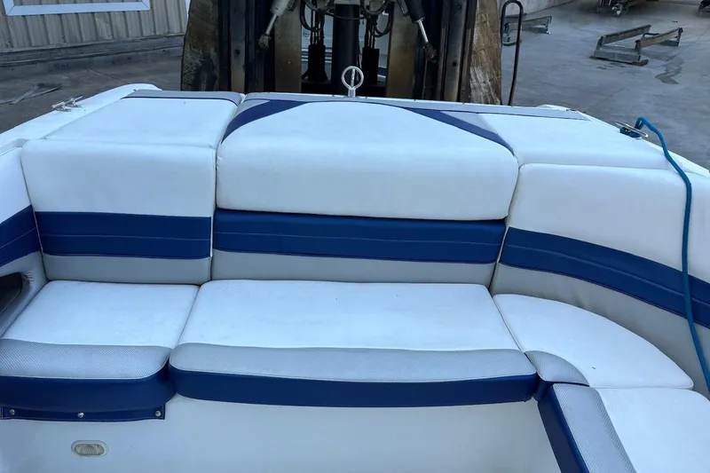 Slide: The Image of White and blue seating on a 2002 Cobalt 240 boat, dockside view. - 11