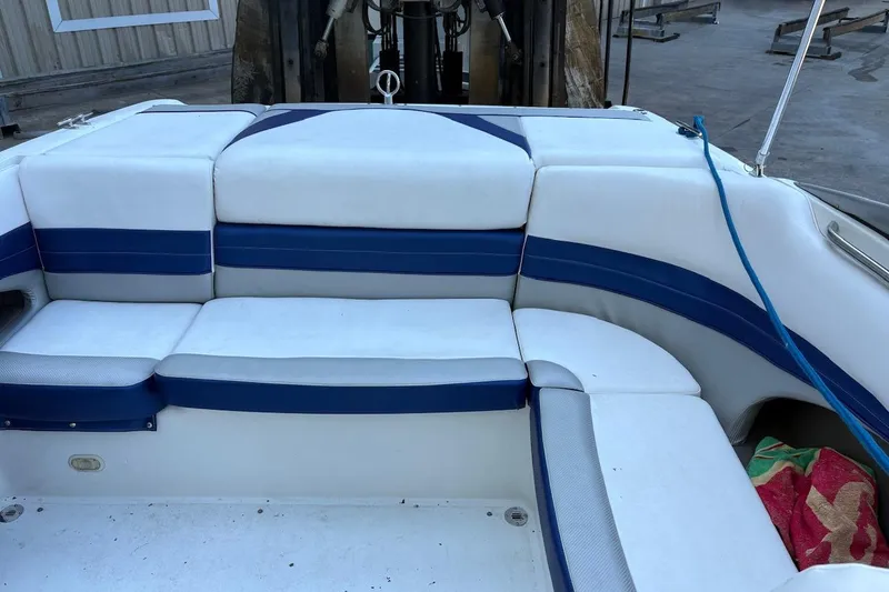 Slide: The Image of Interior seating of a 2002 Cobalt 240 boat with blue and white upholstery. - 12