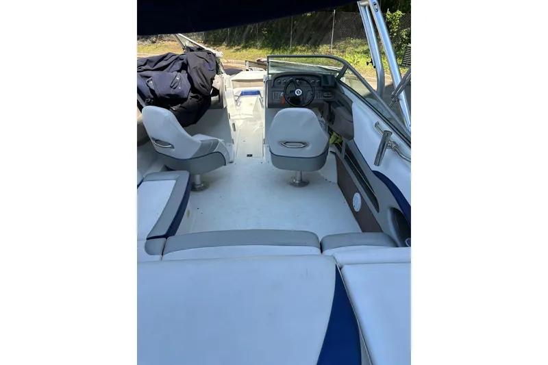 Slide: The Image of Interior of a 2002 Cobalt 240 boat with seating and steering wheel. - 7