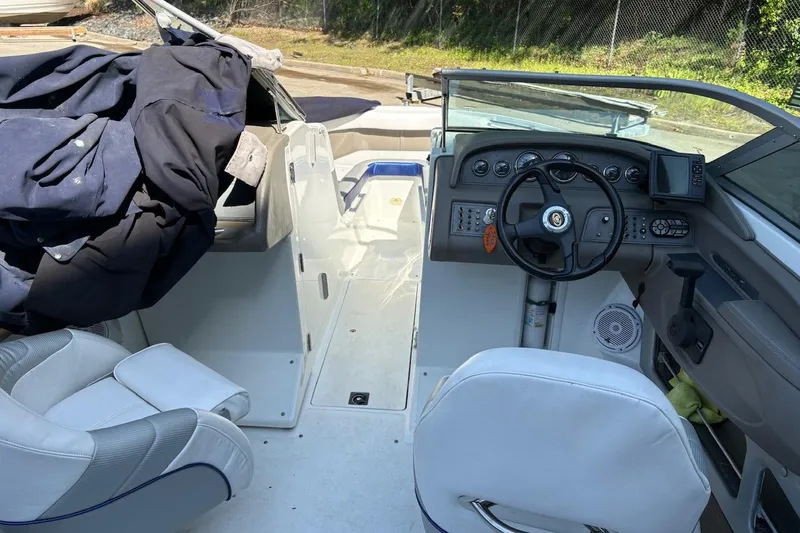 Slide: The Image of Interior of a 2002 Cobalt 240 boat with steering wheel and dashboard. - 8