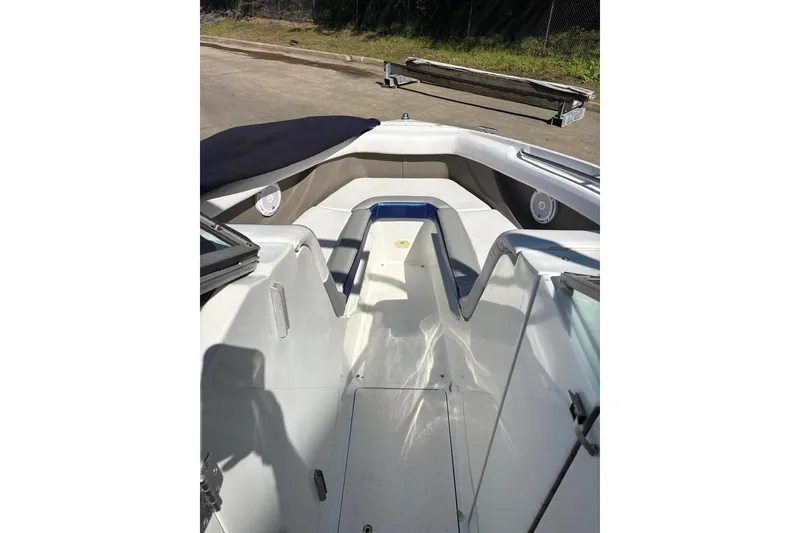 Slide: The Image of Interior view of a 2002 Cobalt 240 boat, featuring seating and speakers. - 9