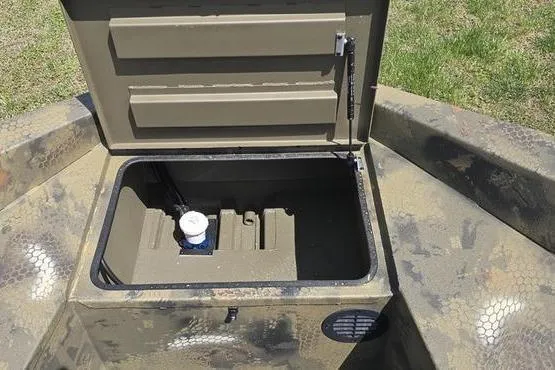 Slide: The Image of Open storage compartment of 2026 Havoc 1553 VJST boat on grassy background. - 3