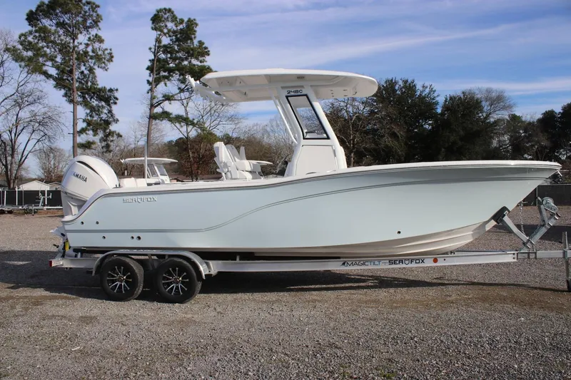 The Image of 2026 Sea Fox 248 Commander boat on trailer, parked outdoors under clear sky. - 0