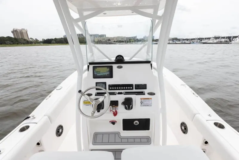 Slide: The Image of Manufacturer Provided Image: 2025 Sea Fox 248 Commander boat dashboard with steering wheel and controls on open water. - 14