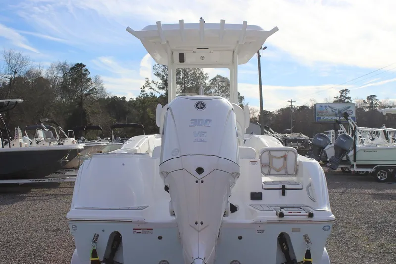 Slide: The Image of 2026 Sea Fox 248 Commander boat with powerful outboard engine, displayed outdoors. - 2