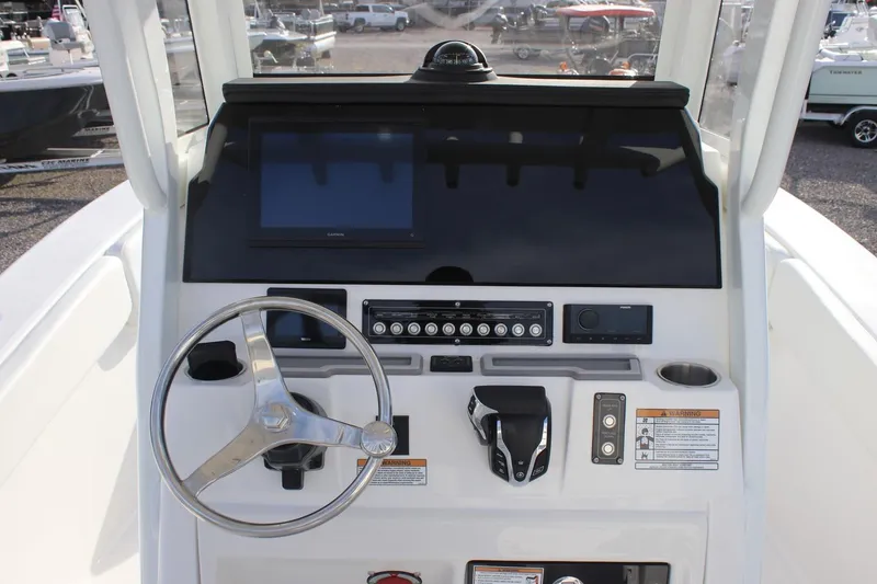 Slide: The Image of 2026 Sea Fox 248 Commander boat dashboard with steering wheel and control panel. - 4