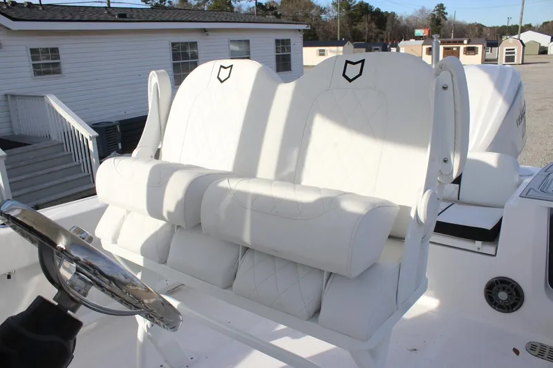 Slide: The Image of 2026 Sea Fox 248 Commander boat with white cushioned seating and steering wheel. - 5