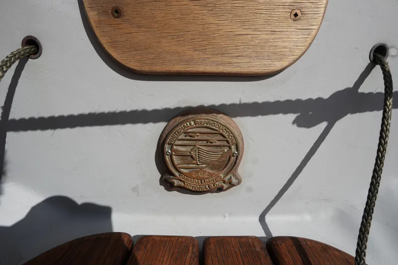 Slide: The Image of Wooden plaque and emblem on 2006 Whitehall Spirit 19 boat interior. - 3