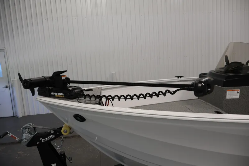 Slide: The Image of 2026 Crestliner 1650 Kodiak SC boat with Minn Kota PowerDrive trolling motor in a showroom. - 15