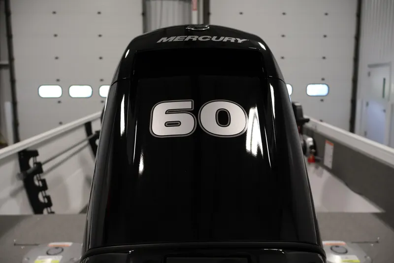 Slide: The Image of 2026 Crestliner 1650 Kodiak SC with Mercury 60 horsepower outboard motor in a garage. - 41