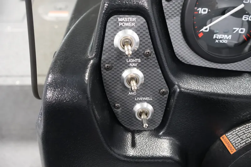Slide: The Image of Dashboard controls of 2026 Crestliner 1650 Kodiak SC boat, featuring switches and RPM gauge. - 27