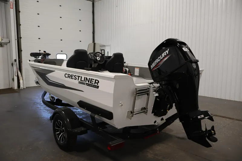 Slide: The Image of 2026 Crestliner 1650 Kodiak SC boat with Mercury engine in a garage setting. - 11