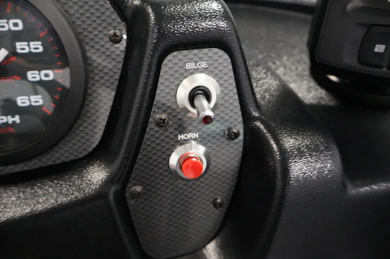Slide: The Image of Dashboard controls of 2026 Crestliner 1650 Kodiak SC boat, featuring bilge and horn switches. - 28