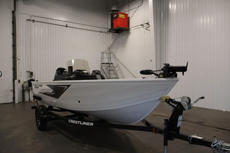 Slide: The Image of 2026 Crestliner 1650 Kodiak SC boat in a warehouse, on a trailer. - 7