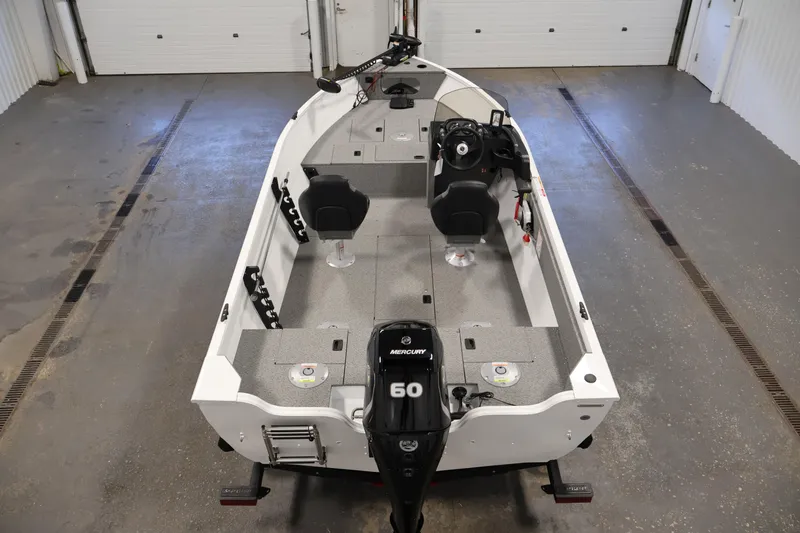 Slide: The Image of 2026 Crestliner 1650 Kodiak SC fishing boat with Mercury 60 engine in a garage. - 14