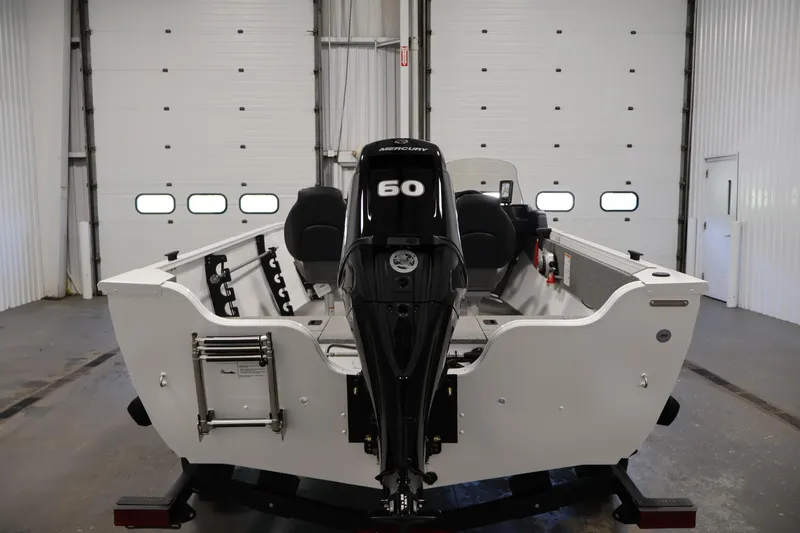 Slide: The Image of 2026 Crestliner 1650 Kodiak SC boat with Mercury 60 engine in a garage setting. - 10