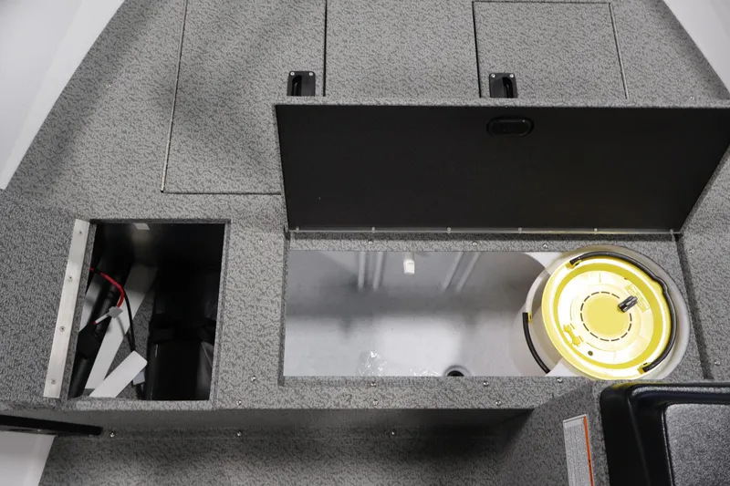 Slide: The Image of Interior compartments of 2026 Crestliner 1650 Kodiak SC boat, featuring storage and utility spaces. - 22