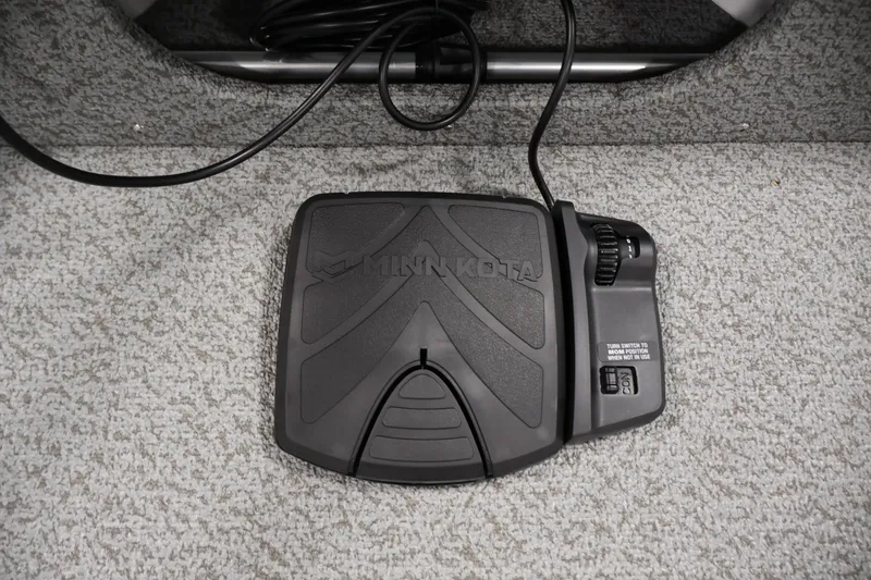 Slide: The Image of Minn Kota foot pedal on 2026 Crestliner 1650 Kodiak SC boat carpeted floor. - 18