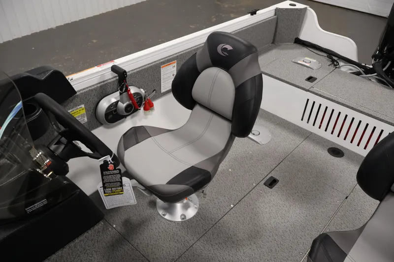 Slide: The Image of 2026 Crestliner 1650 Kodiak SC boat interior with steering wheel and comfortable seating. - 31