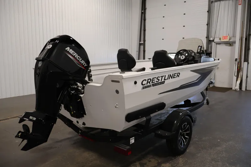 Slide: The Image of 2026 Crestliner 1650 Kodiak SC boat with Mercury engine in a garage setting. - 9